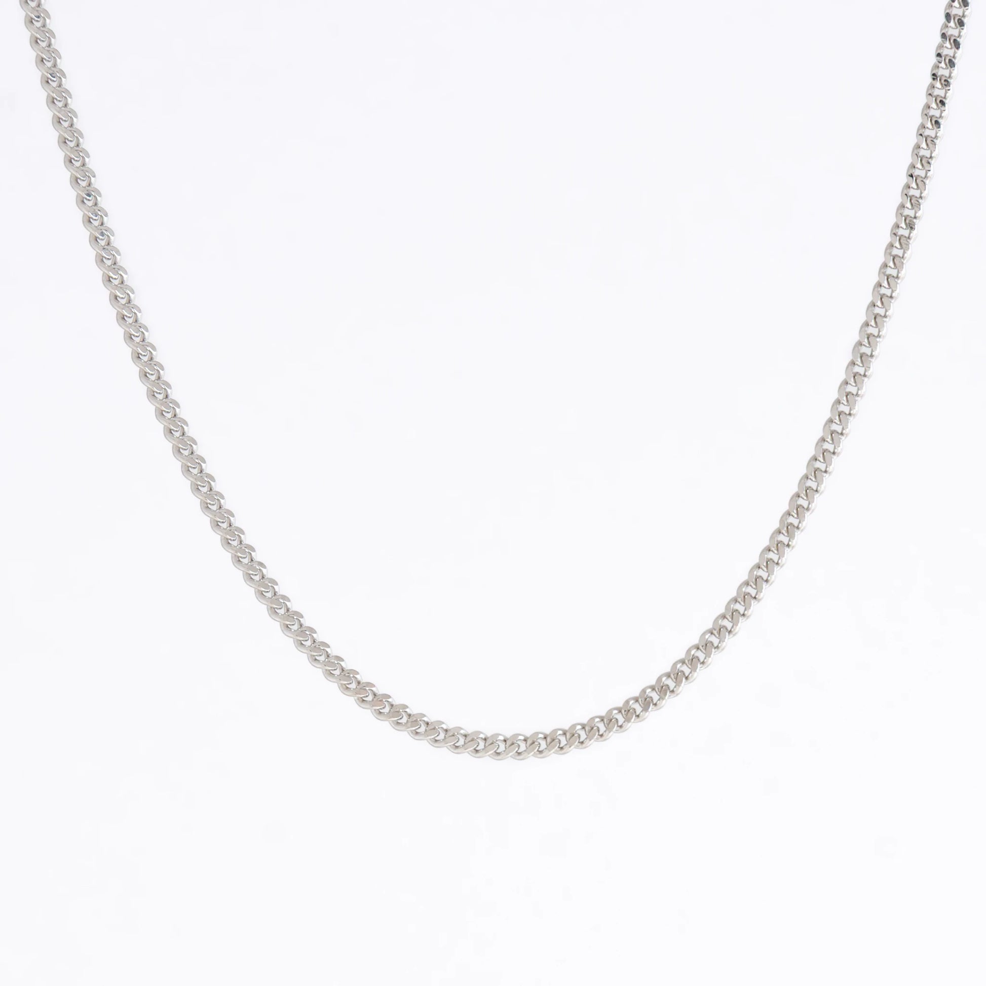 Curb chain necklace on a light gray background