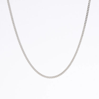 Silver curb chain necklace on a light gray background