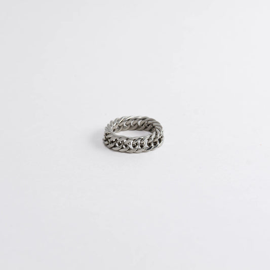Silver braided cuban chain stainless steel ring on a white background
