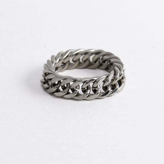 Silver braided cuban chain stainless steel ring on a white background