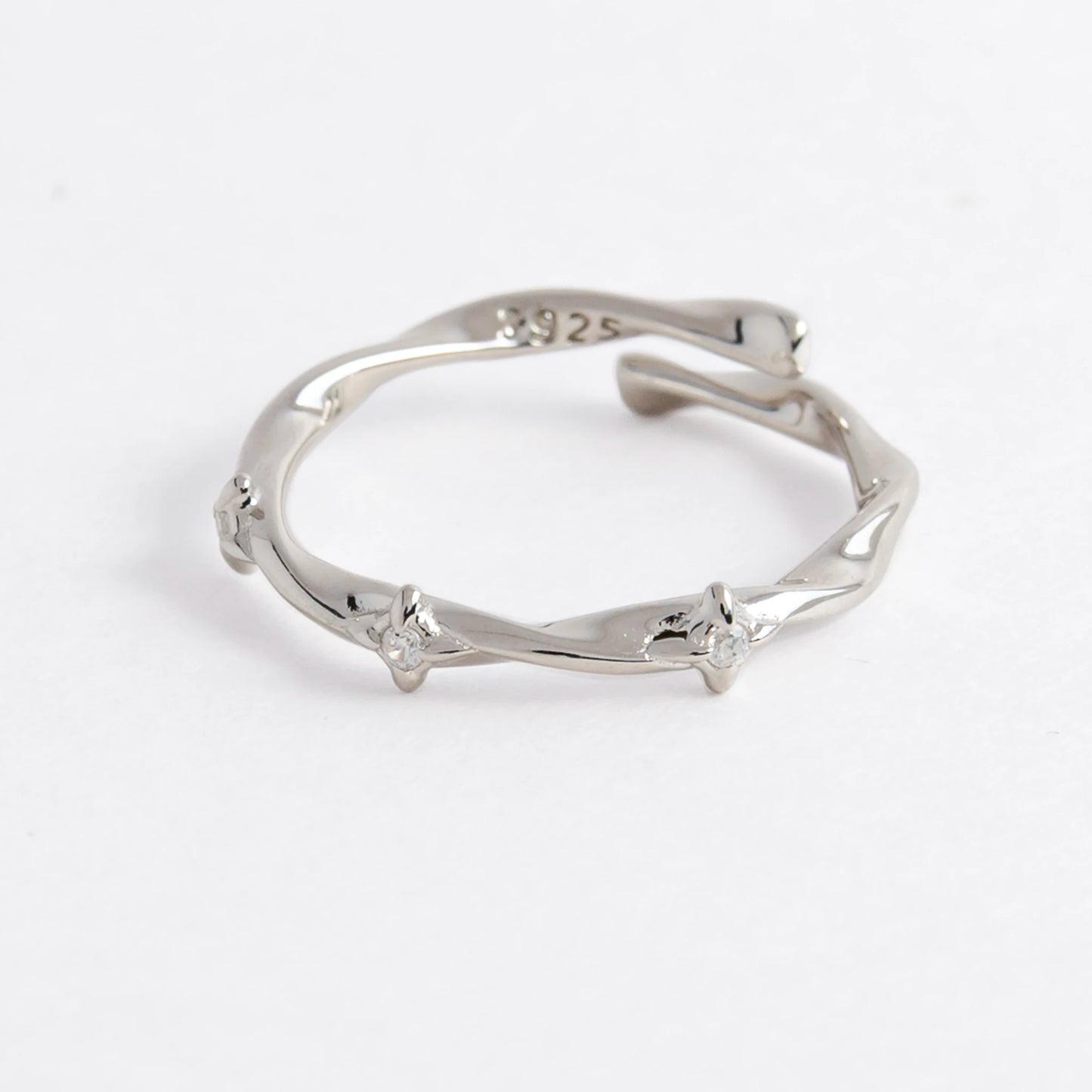 Silver wrap ring on a light gray background