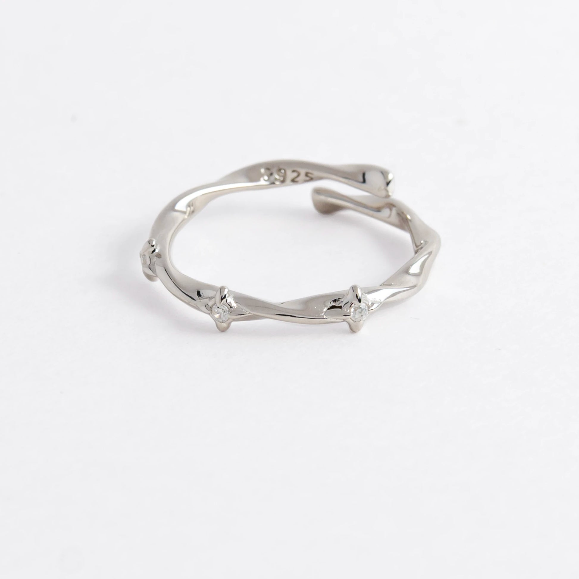 Silver wrap ring on a light gray background