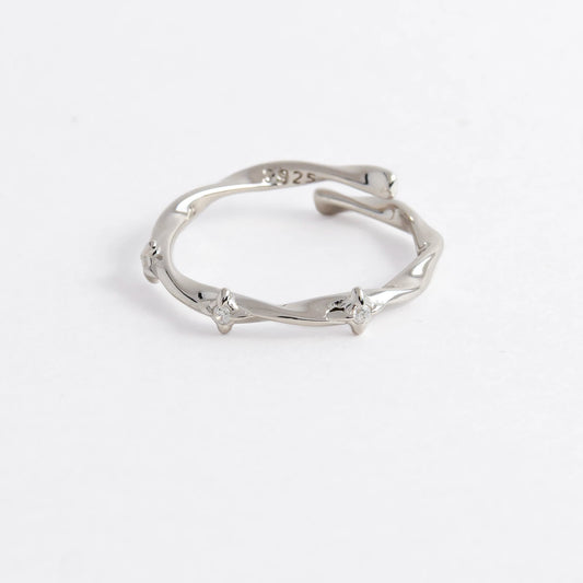 Silver wrap ring on a light gray background