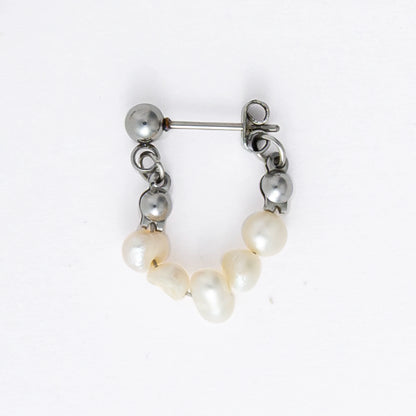 A pair of silver-colored thin pearl hoop earrings, displayed against a white background