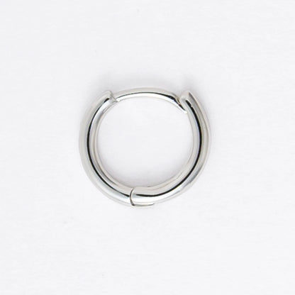 Two silver hoop earrings on a light gray background