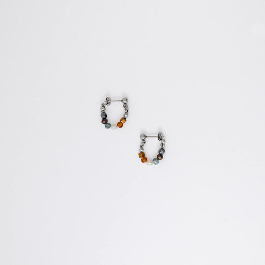 Pair of stainless steel beaded hoop earrings on a white background