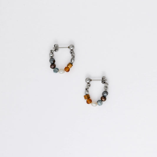 Pair of stainless steel beaded hoop earrings on a white background
