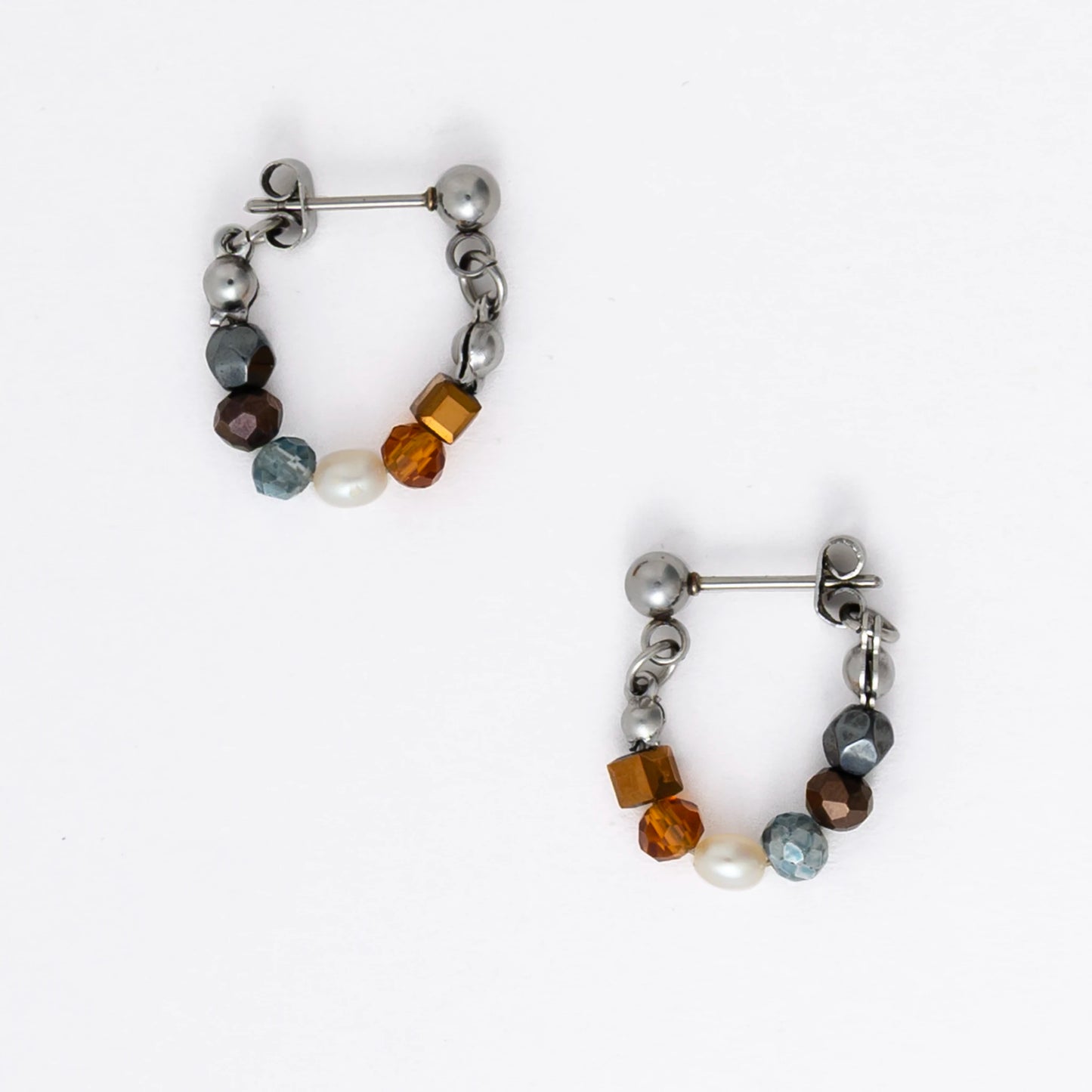 Pair of stainless steel beaded hoop earrings on a white background