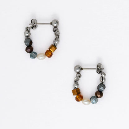 Pair of stainless steel beaded hoop earrings on a white background