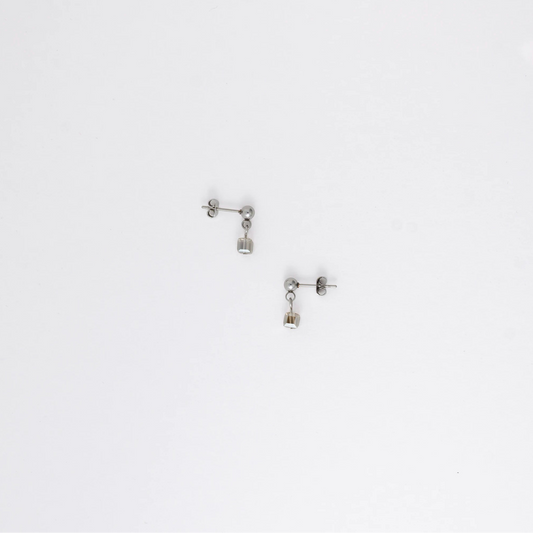 Pair of silver stainless steel ball stud earrings with sugar cube gray glass beads on a white background