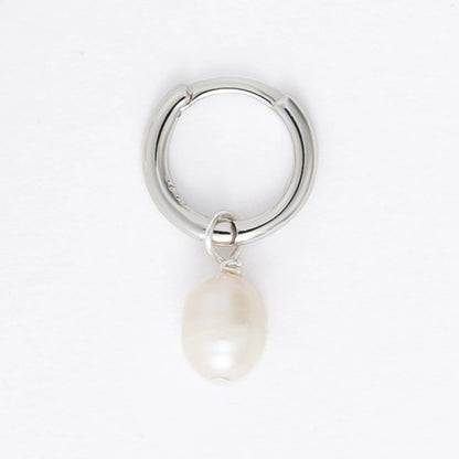 Pair of silver hoop earrings with pearl drops on a light gray background
