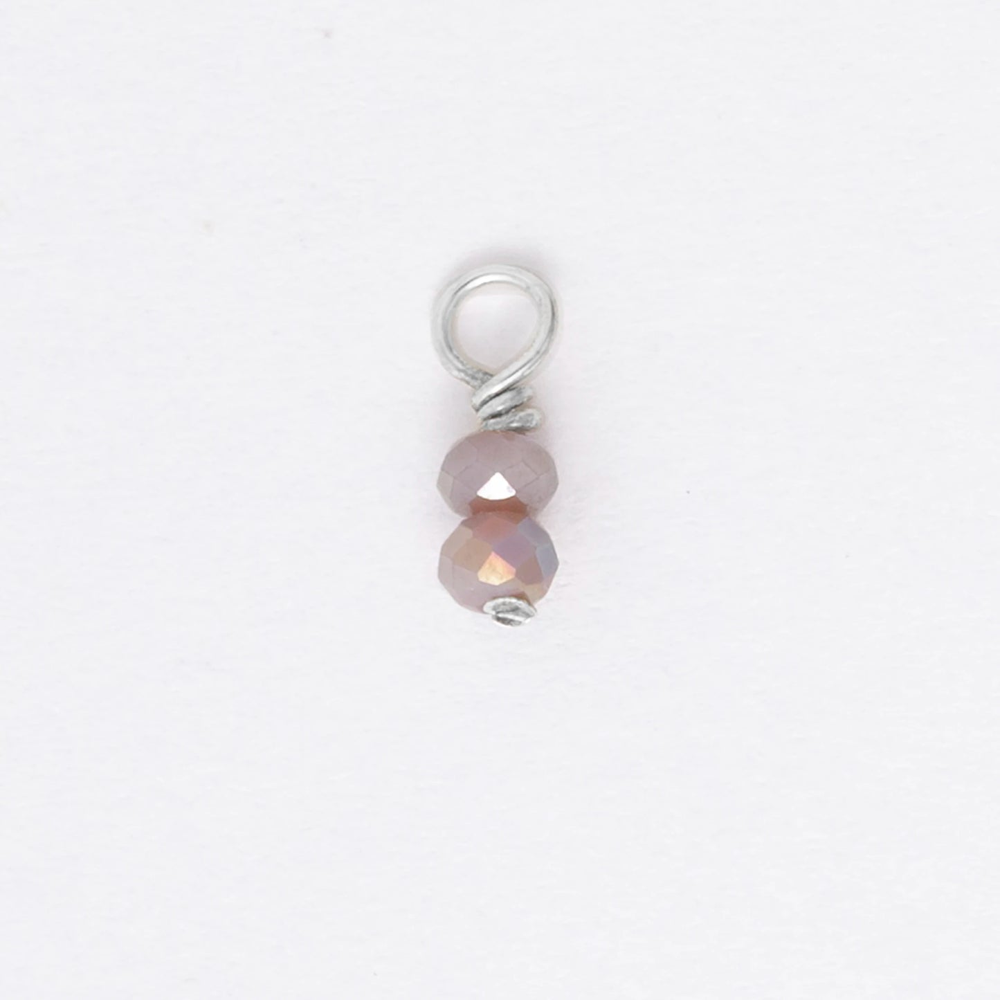 Two small purple glass bead charm on a white background