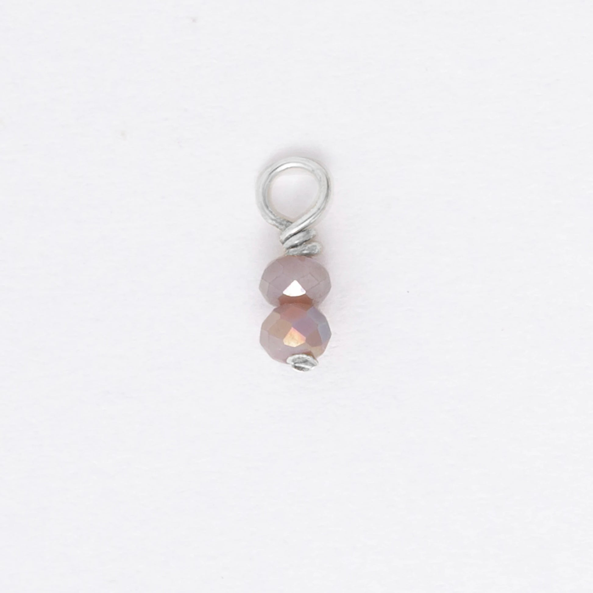 Two small purple glass bead charm on a white background