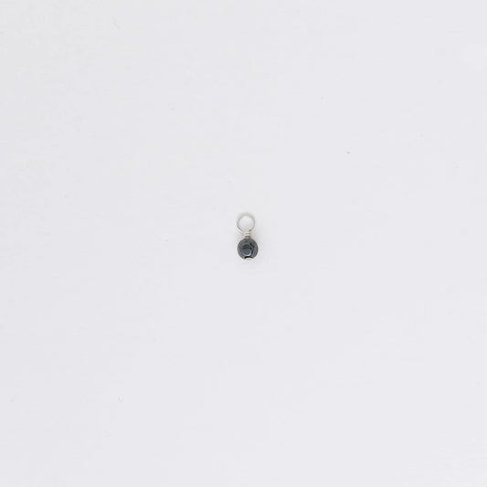 Small black and silver pendant on a white background