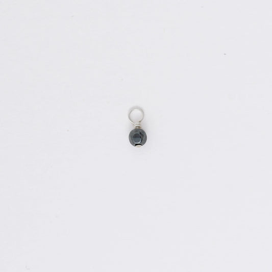 Small black and silver pendant on a white background