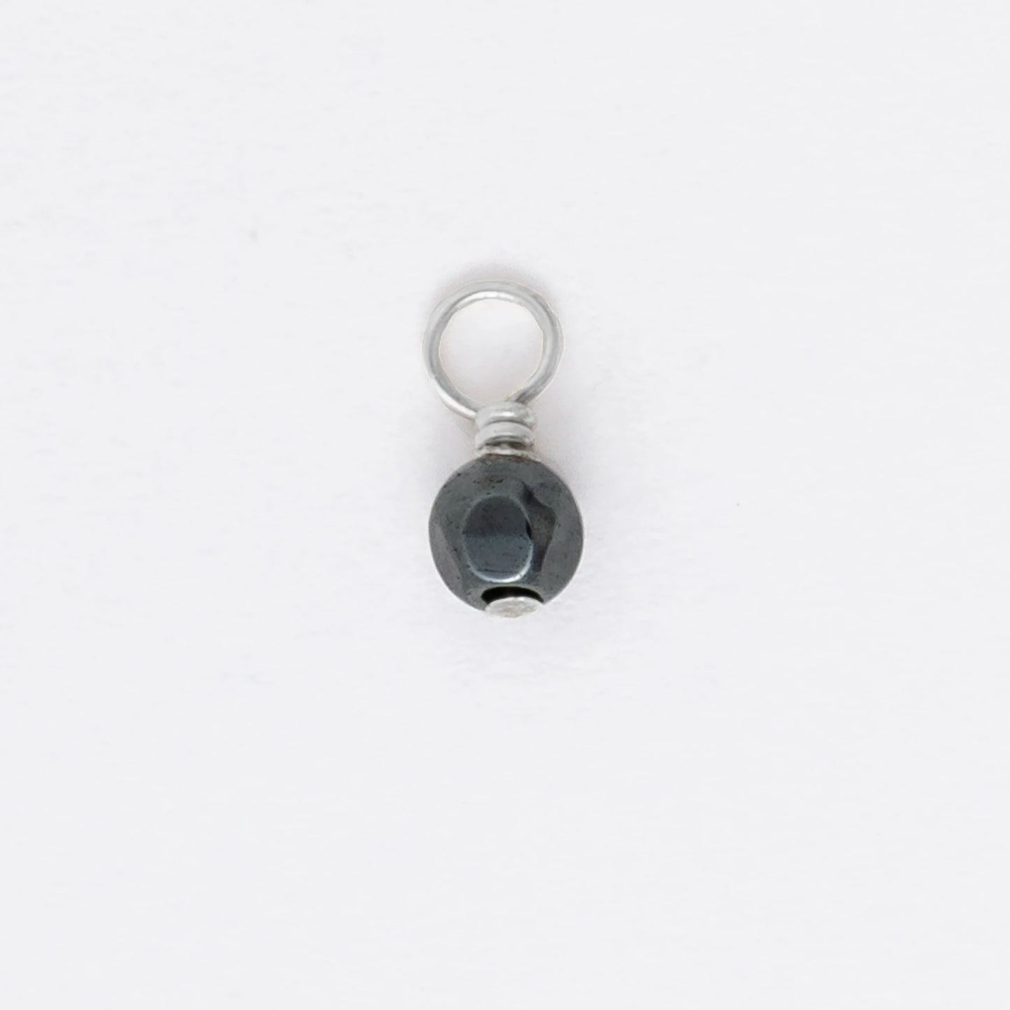 Small black and silver pendant on a white background