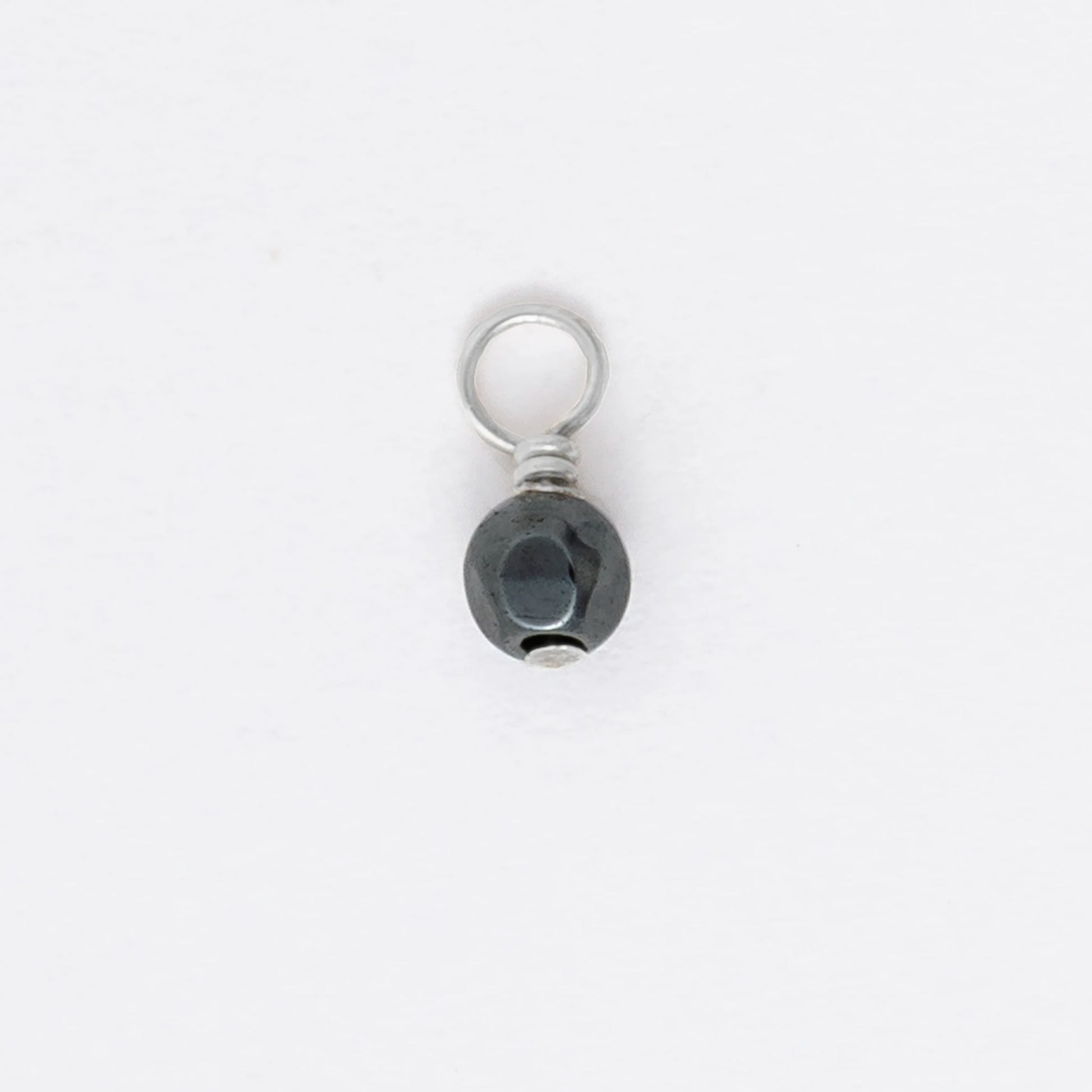Small black and silver pendant on a white background