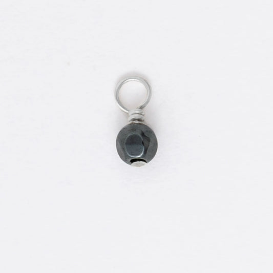 Small black and silver pendant on a white background