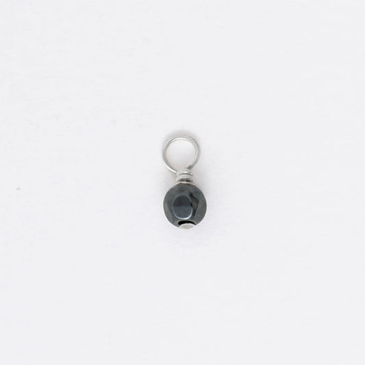 Small black and silver pendant on a white background