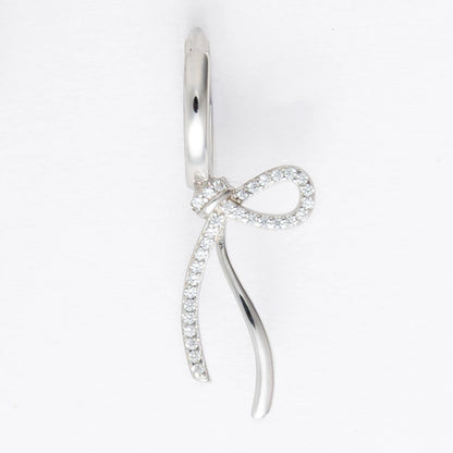 Pair of silver earrings with bow design on a light gray background