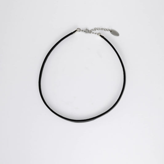 Black leather choker necklace on a light gray background