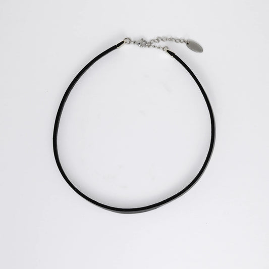 Black leather choker necklace on a light gray background