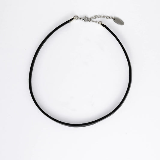 Black leather choker necklace on a light gray background