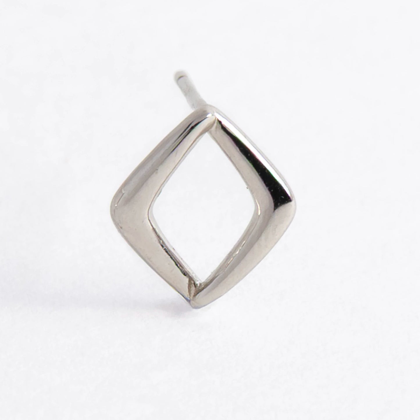 Pair of silver square earrings on a light gray background
