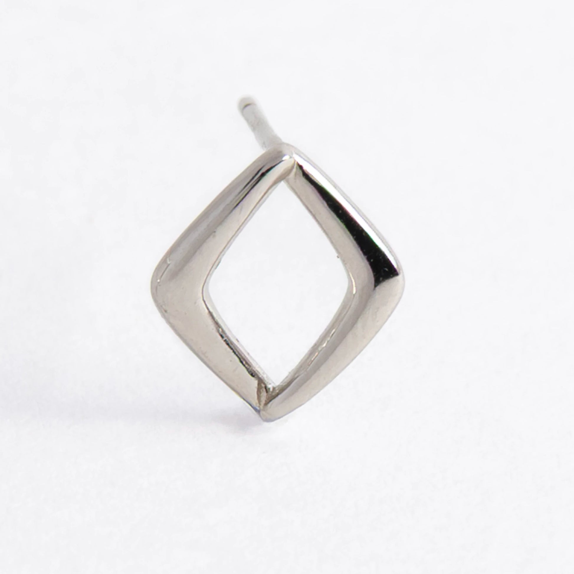 Pair of silver square earrings on a light gray background