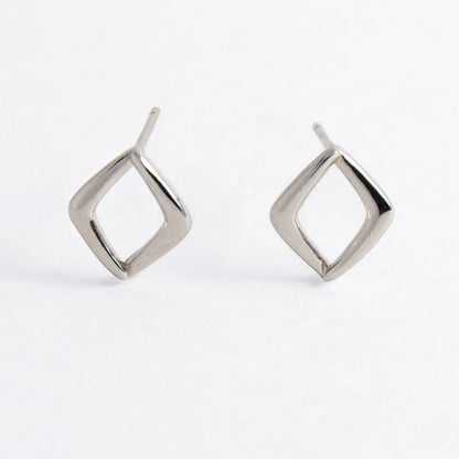 Pair of silver square earrings on a light gray background
