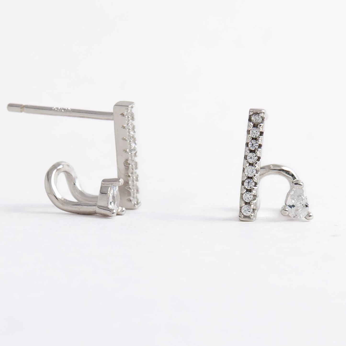 Pair of silver bar earrings on a light gray background