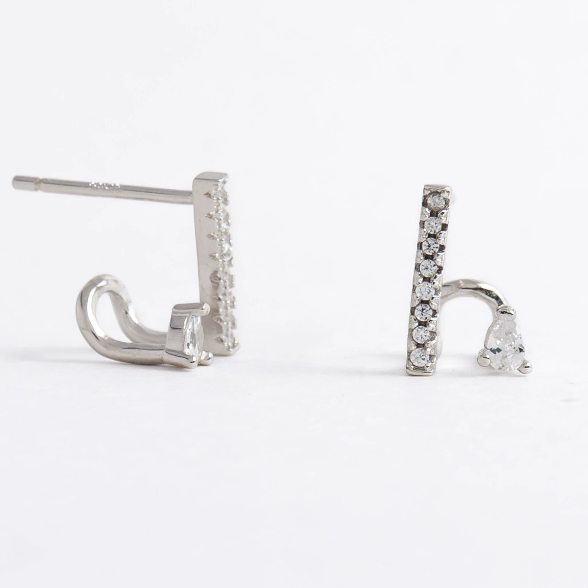 Pair of silver bar earrings on a light gray background