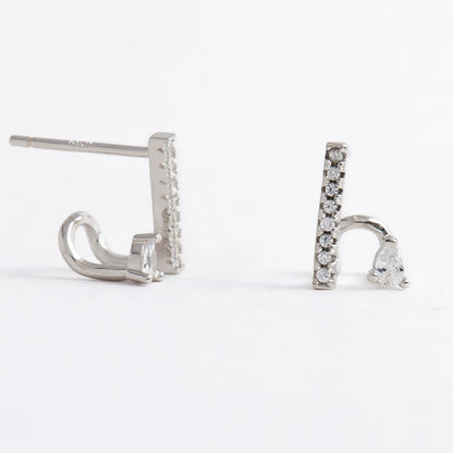 Pair of silver bar earrings on a light gray background