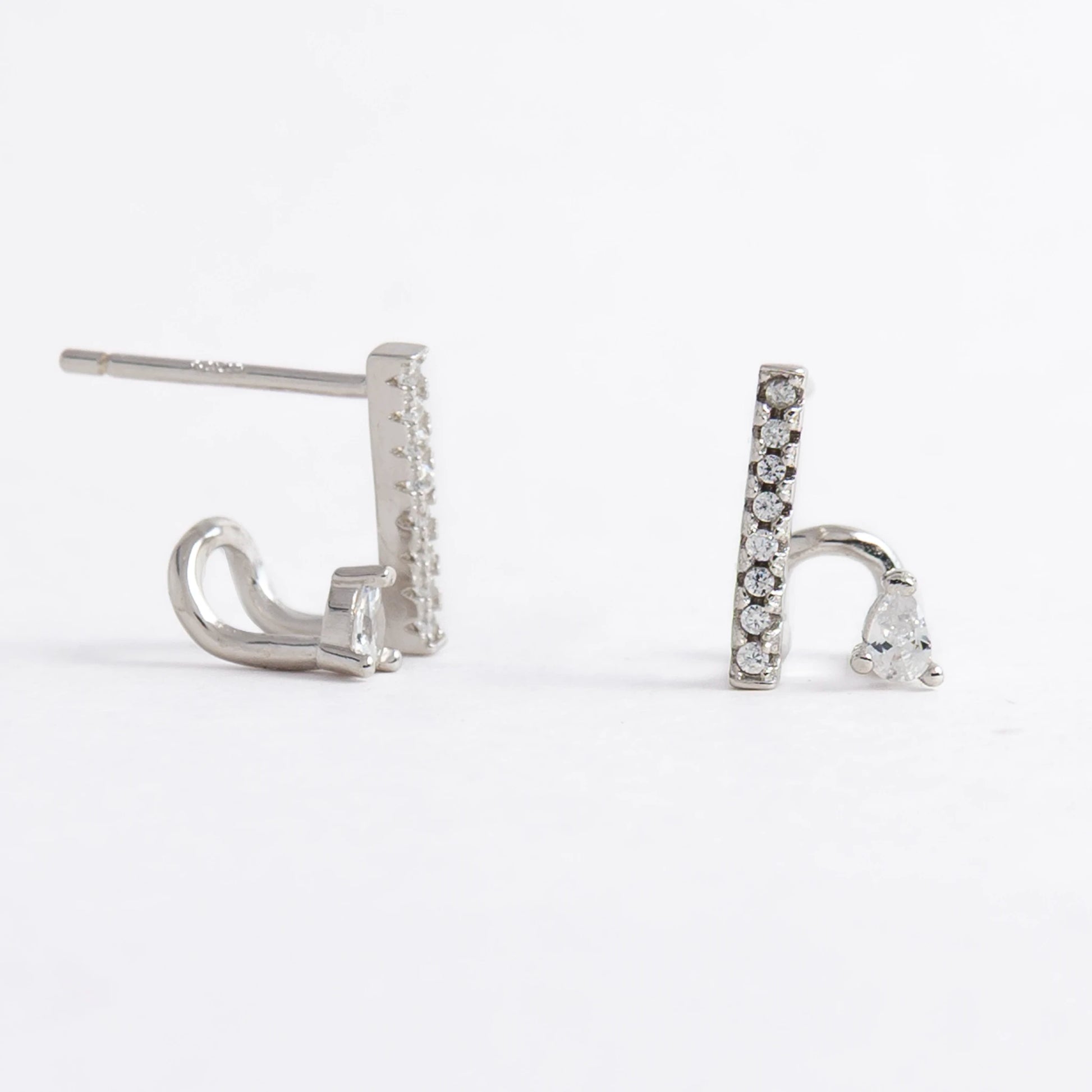 Pair of silver bar earrings on a light gray background