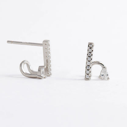 Pair of silver bar earrings on a light gray background