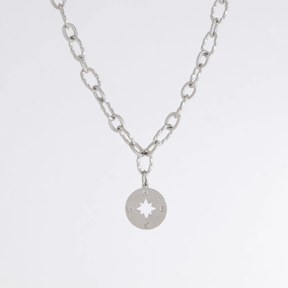 Silver layered paperclip necklaces non-tarnish with compass charm on a light gray background