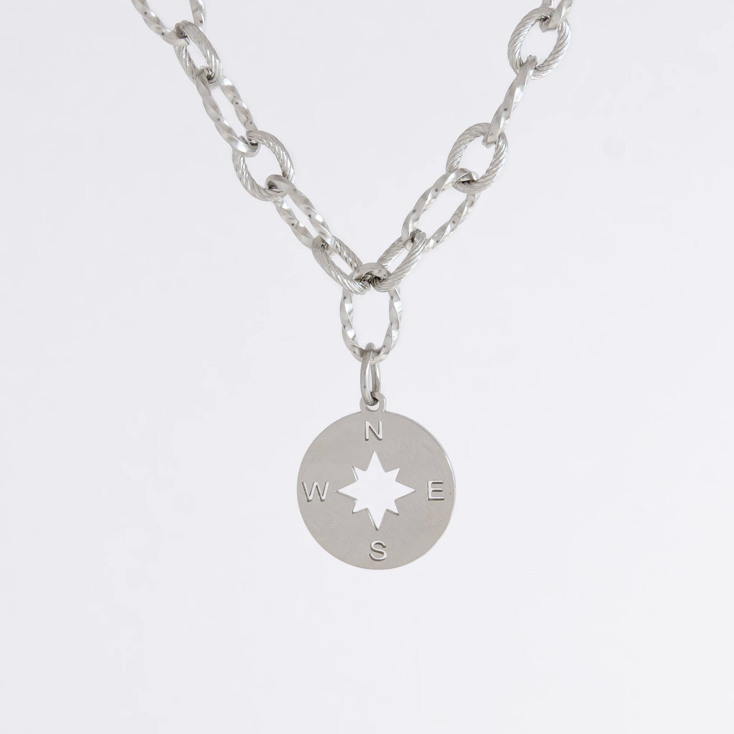 Silver layered paperclip necklaces non-tarnish with compass charm on a light gray background