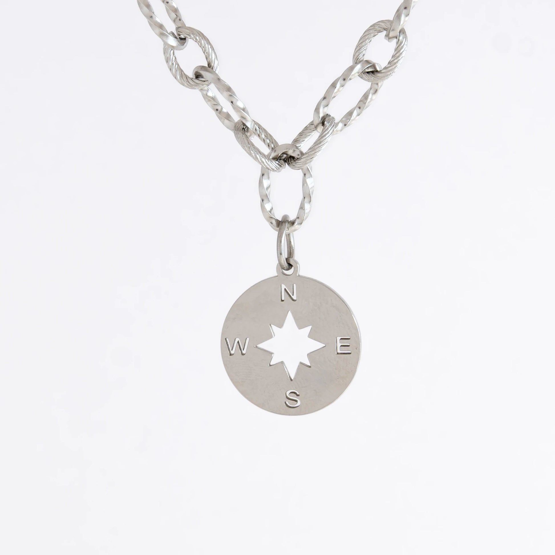 Silver layered paperclip necklaces non-tarnish with compass charm on a light gray background