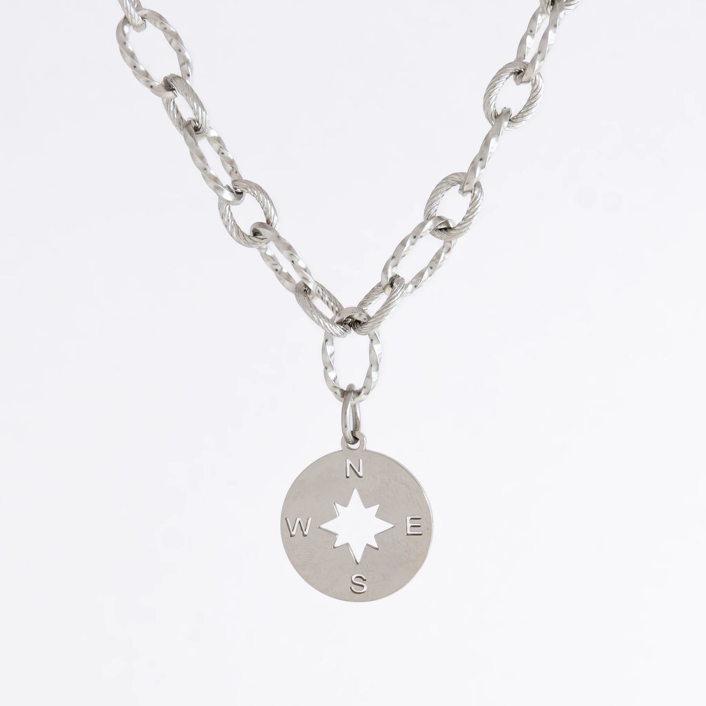 Silver layered paperclip necklaces non-tarnish with compass charm on a light gray background