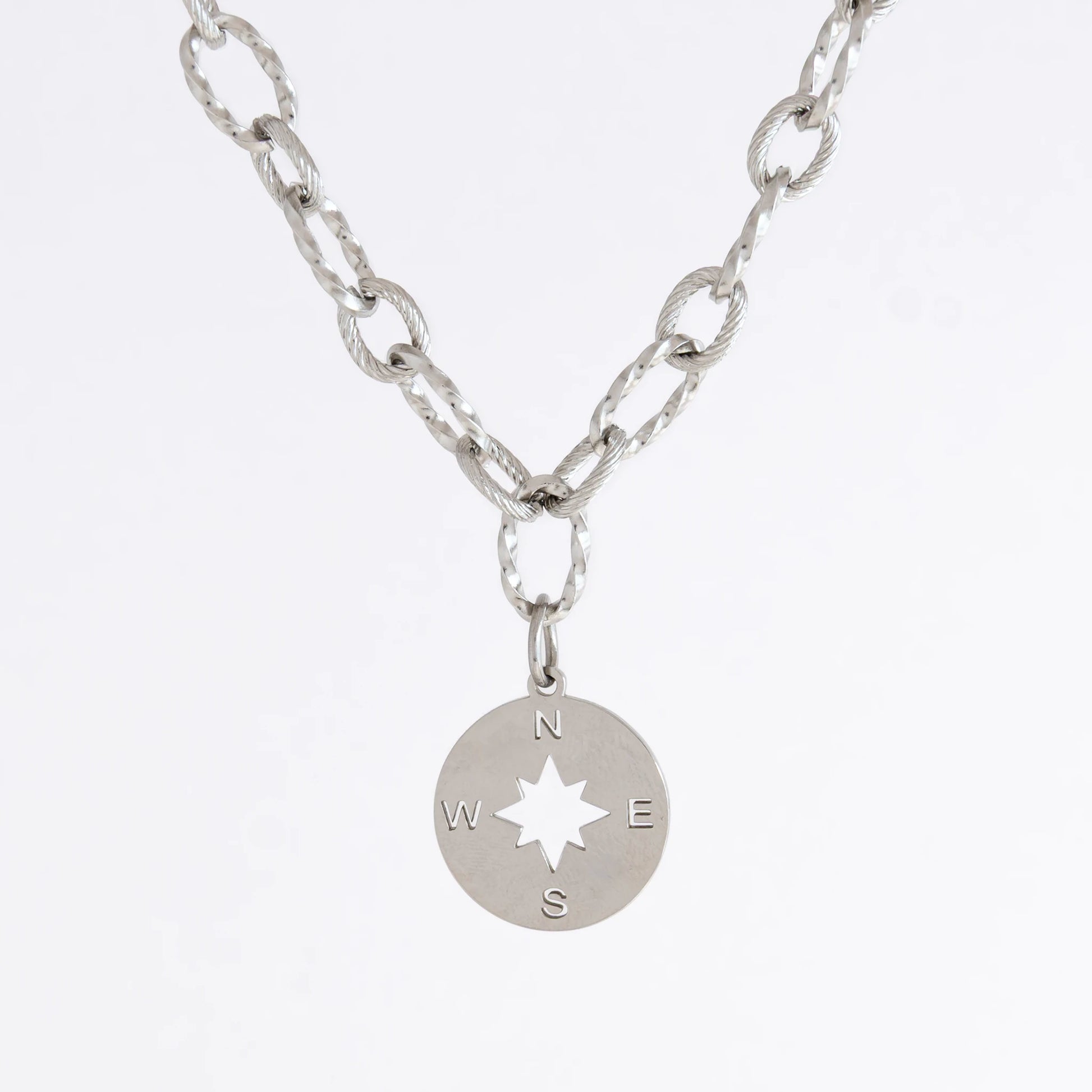 Silver layered paperclip necklaces non-tarnish with compass charm on a light gray background