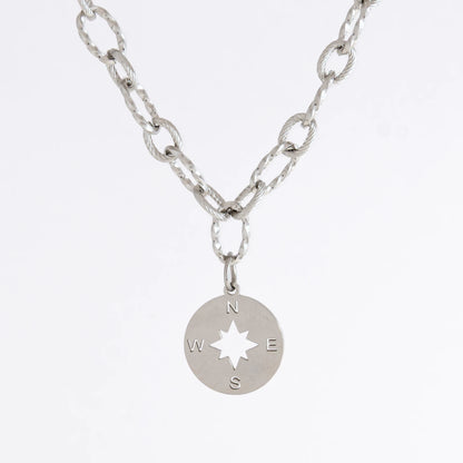 Silver layered paperclip necklaces non-tarnish with compass charm on a light gray background
