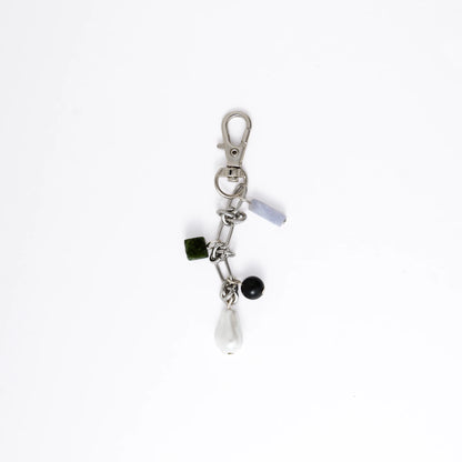 Keychain with various charms on a white background
