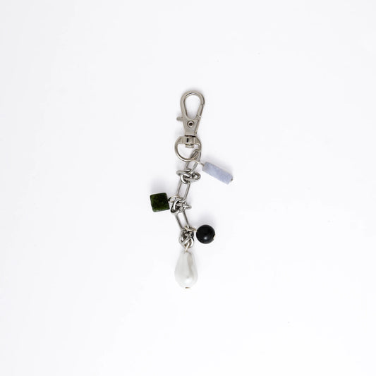 Keychain with various charms on a white background