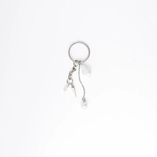 Silver keychain with a small dagger charm on a white background
