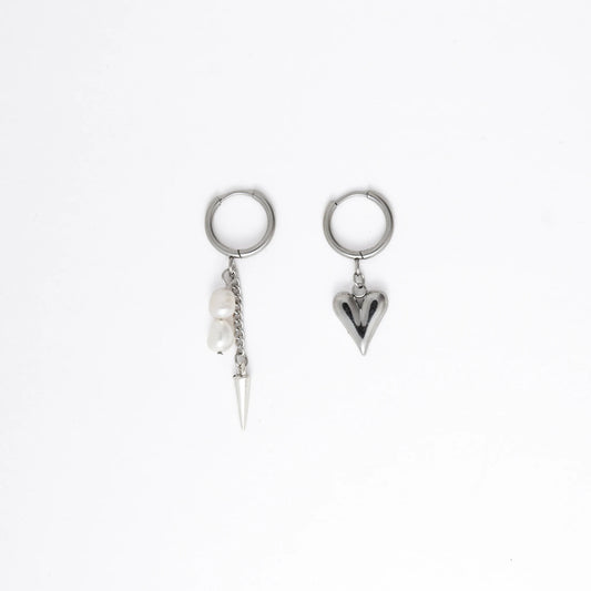 Pair of silver hoop earrings with unique heart and arrow designs on a white background