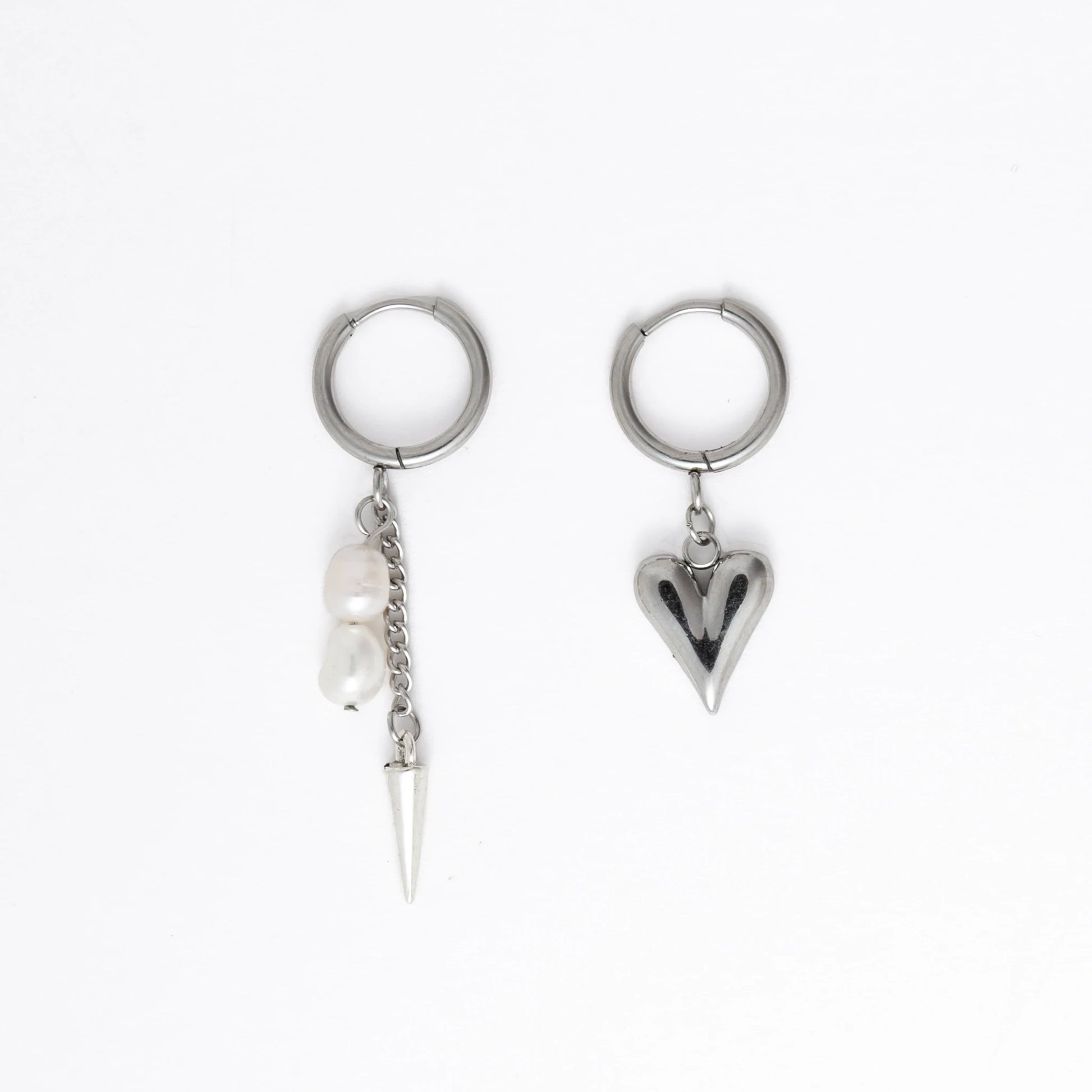 Pair of silver hoop earrings with unique designs on a white background