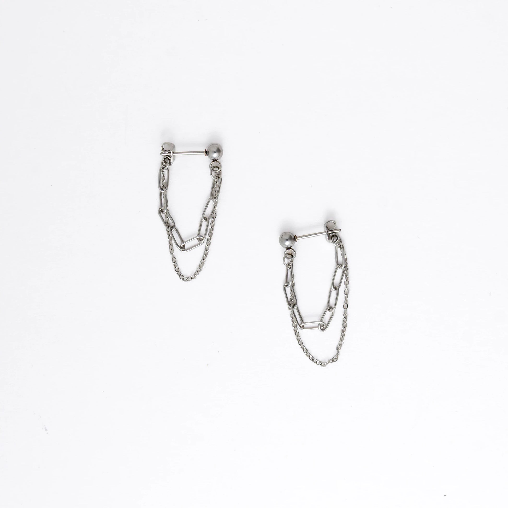 Pair of silver chain earrings on a white background