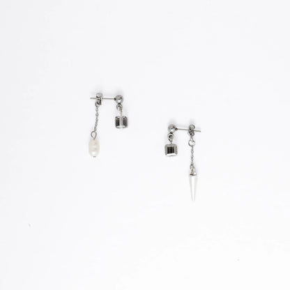 Pair of silver earrings with chain and gemstone pendants on a white background