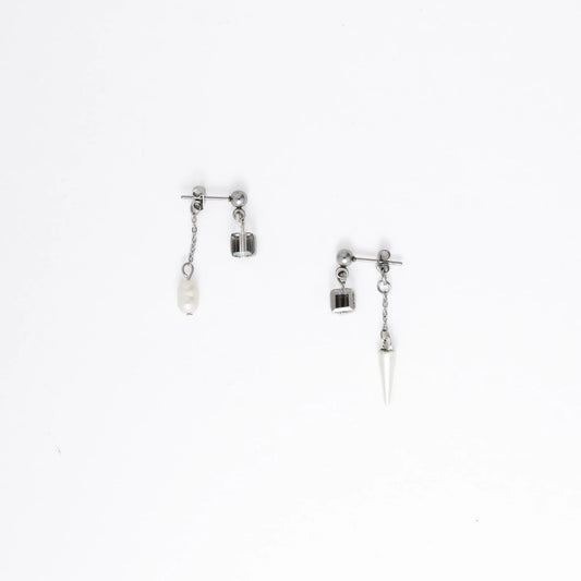 Pair of silver earrings with chain and gemstone pendants on a white background