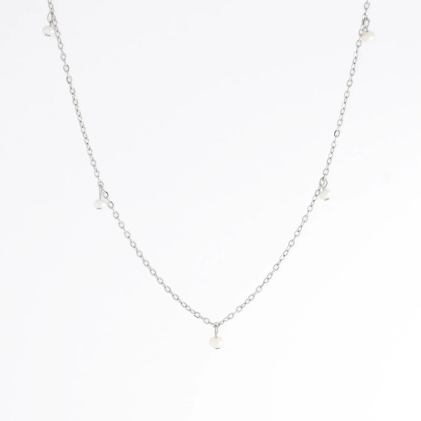 Silver necklace with a small pendant on a white background